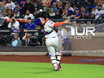 New York Mets catcher Francisco Alvarez #4 makes a catch during the ninth inning of the baseball game against the Boston Red Sox at Citi Fie...