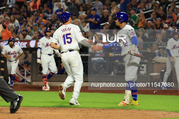 New York Mets Tyrone Taylor #15 scores on a sacrifice fly during the eighth inning of the baseball game against the Boston Red Sox at Citi F...