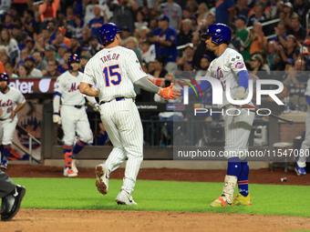 New York Mets Tyrone Taylor #15 scores on a sacrifice fly during the eighth inning of the baseball game against the Boston Red Sox at Citi F...