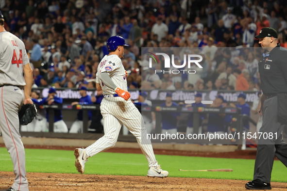 New York Mets Tyrone Taylor #15 scores on a sacrifice fly during the eighth inning of the baseball game against the Boston Red Sox at Citi F...