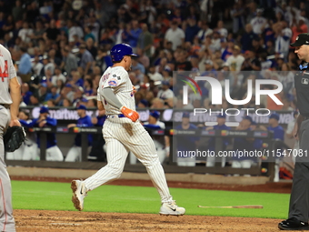 New York Mets Tyrone Taylor #15 scores on a sacrifice fly during the eighth inning of the baseball game against the Boston Red Sox at Citi F...