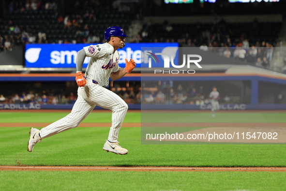 New York Mets Tyrone Taylor #15 scores on a sacrifice fly during the eighth inning of the baseball game against the Boston Red Sox at Citi F...