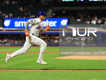 New York Mets Tyrone Taylor #15 scores on a sacrifice fly during the eighth inning of the baseball game against the Boston Red Sox at Citi F...