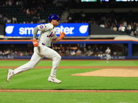 New York Mets Tyrone Taylor #15 scores on a sacrifice fly during the eighth inning of the baseball game against the Boston Red Sox at Citi F...