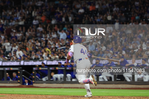 Harrison Bader #44 of the New York Mets hits a sacrifice fly during the ninth inning of the baseball game against the Boston Red Sox at Citi...