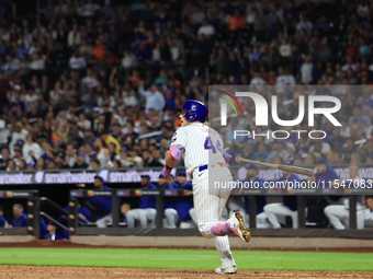 Harrison Bader #44 of the New York Mets hits a sacrifice fly during the ninth inning of the baseball game against the Boston Red Sox at Citi...