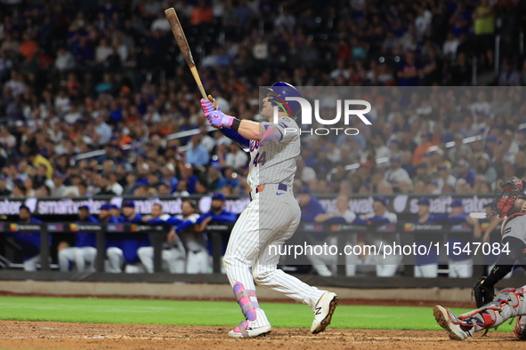 Harrison Bader #44 of the New York Mets hits a sacrifice fly during the ninth inning of the baseball game against the Boston Red Sox at Citi...