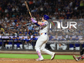 Harrison Bader #44 of the New York Mets hits a sacrifice fly during the ninth inning of the baseball game against the Boston Red Sox at Citi...