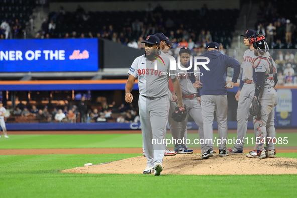 Boston Red Sox pitcher Kenley Jansen #74 is removed from the game by manager Alex Cora #13 during the eighth inning of the baseball game aga...