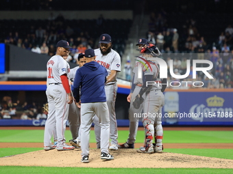 Boston Red Sox pitcher Kenley Jansen #74 is removed from the game by manager Alex Cora #13 during the eighth inning of the baseball game aga...