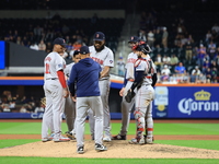 Boston Red Sox pitcher Kenley Jansen #74 is removed from the game by manager Alex Cora #13 during the eighth inning of the baseball game aga...