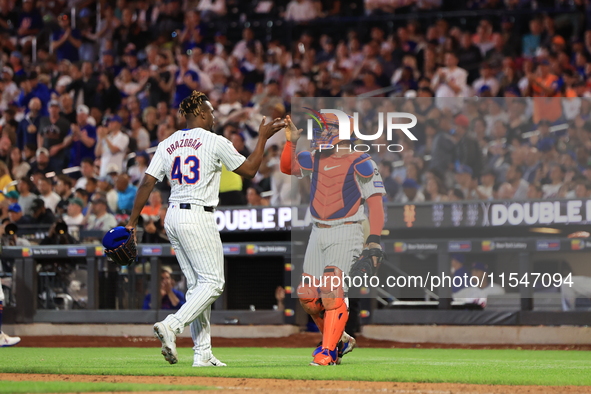 New York Mets relief pitcher Huascar Brazoban #43 celebrates with catcher Francisco Alvarez #4 during the seventh inning of the baseball gam...