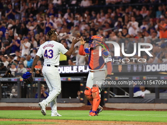 New York Mets relief pitcher Huascar Brazoban #43 celebrates with catcher Francisco Alvarez #4 during the seventh inning of the baseball gam...