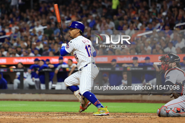 Francisco Lindor #12 of the New York Mets doubles during the fifth inning of the baseball game against the Boston Red Sox at Citi Field in C...