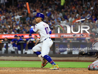 Francisco Lindor #12 of the New York Mets doubles during the fifth inning of the baseball game against the Boston Red Sox at Citi Field in C...