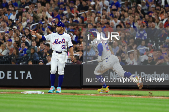 Francisco Lindor #12 of the New York Mets doubles during the fifth inning of the baseball game against the Boston Red Sox at Citi Field in C...