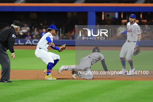 Boston Red Sox Connor Wong #12 is caught in a rundown after attempting to steal second base during the fourth inning of the baseball game ag...