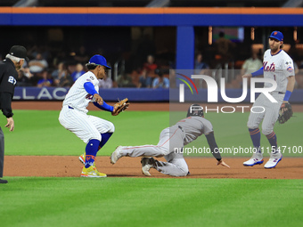 Boston Red Sox Connor Wong #12 is caught in a rundown after attempting to steal second base during the fourth inning of the baseball game ag...