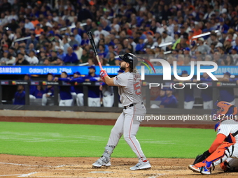 Boston Red Sox Wilyer Abreu #52 hits a sacrifice fly during the third inning of the baseball game against the New York Mets at Citi Field in...