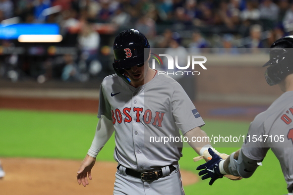 Nick Sogard #75 of the Boston Red Sox scores on a sacrifice fly during the third inning of the baseball game against the New York Mets at Ci...