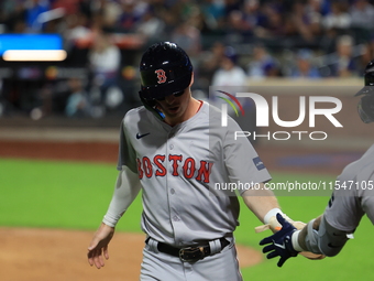 Nick Sogard #75 of the Boston Red Sox scores on a sacrifice fly during the third inning of the baseball game against the New York Mets at Ci...