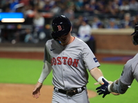 Nick Sogard #75 of the Boston Red Sox scores on a sacrifice fly during the third inning of the baseball game against the New York Mets at Ci...