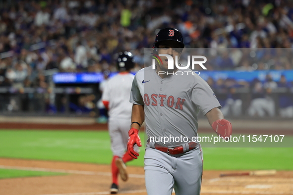 Enmanuel Valdez #47 of the Boston Red Sox scores from second base during the third inning of the baseball game against the New York Mets at...