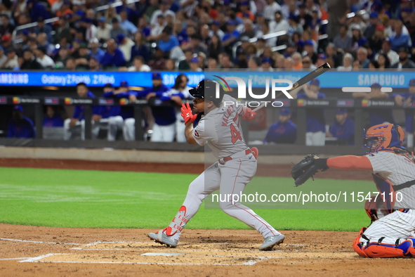 Enmanuel Valdez #47 of the Boston Red Sox singles during the third inning of the baseball game against the New York Mets at Citi Field in Co...