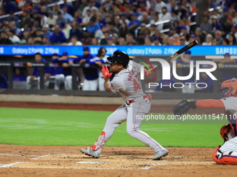 Enmanuel Valdez #47 of the Boston Red Sox singles during the third inning of the baseball game against the New York Mets at Citi Field in Co...