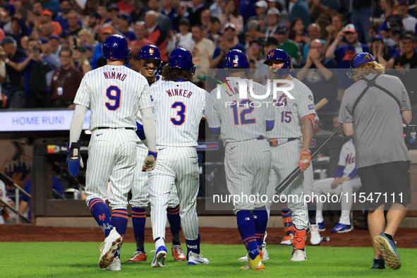 Jesse Winker #3 of the New York Mets is congratulated after hitting a grand slam home run during the first inning of the baseball game again...