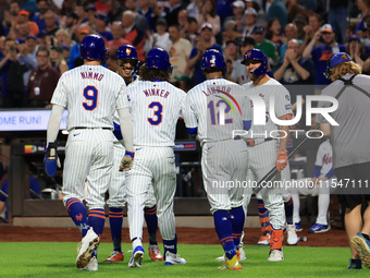 Jesse Winker #3 of the New York Mets is congratulated after hitting a grand slam home run during the first inning of the baseball game again...