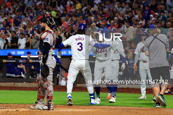 Jesse Winker #3 of the New York Mets is congratulated after hitting a grand slam home run during the first inning of the baseball game again...