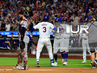 Jesse Winker #3 of the New York Mets is congratulated after hitting a grand slam home run during the first inning of the baseball game again...