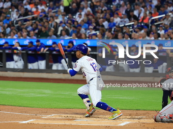 New York Mets Francisco Lindor #12 singles during the first inning of the baseball game against the Boston Red Sox at Citi Field in Corona,...