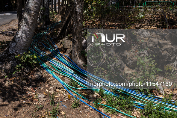 A number of water hoses are around the house and road surface during drought season in Selopamioro Village, Bantul Regency, Yogyakarta Provi...