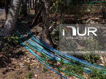 A number of water hoses are around the house and road surface during drought season in Selopamioro Village, Bantul Regency, Yogyakarta Provi...