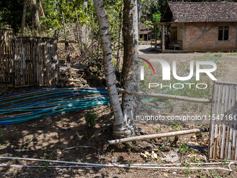 A number of water hoses are around the house and road surface during drought season in Selopamioro Village, Bantul Regency, Yogyakarta Provi...