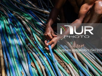 A man connects a water hose to the only water source to his house during drought season in Selopamioro Village, Bantul Regency, Yogyakarta P...