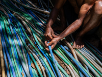 A man connects a water hose to the only water source to his house during drought season in Selopamioro Village, Bantul Regency, Yogyakarta P...