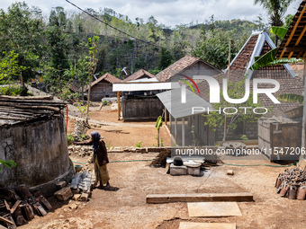 A villager stands near the water source as he waits to collect water during the drought season in Tepus Village, Gunung Kidul Regency, Yogya...