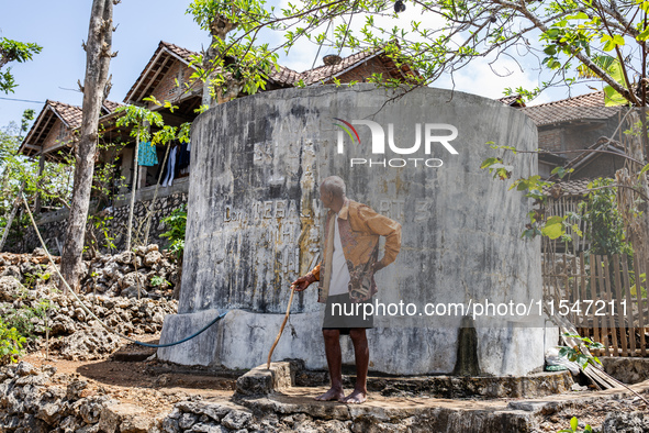 A villager stands near the water source as he waits to collect water during the drought season in Tepus Village, Gunung Kidul Regency, Yogya...