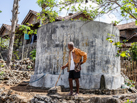 A villager stands near the water source as he waits to collect water during the drought season in Tepus Village, Gunung Kidul Regency, Yogya...