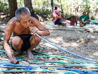 Sarjono (73), an elderly blind man, takes water from the only source of water by sucking it up and flowing it through a hose to his house du...