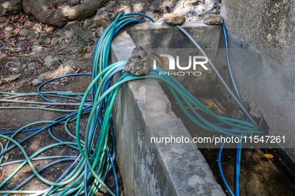 A number of water hoses are around the house and road surface during drought season in Selopamioro Village, Bantul Regency, Yogyakarta Provi...