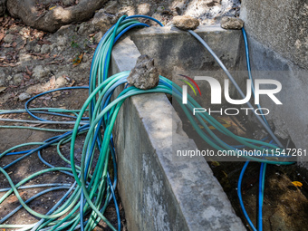 A number of water hoses are around the house and road surface during drought season in Selopamioro Village, Bantul Regency, Yogyakarta Provi...