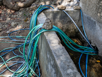 A number of water hoses are around the house and road surface during drought season in Selopamioro Village, Bantul Regency, Yogyakarta Provi...