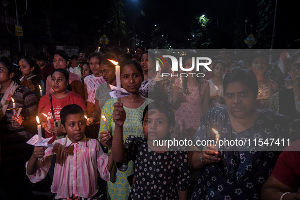 Citizens light candles in solidarity with the victim doctor who was raped and murdered at RG Kar Medical College and Hospital, during a prot...