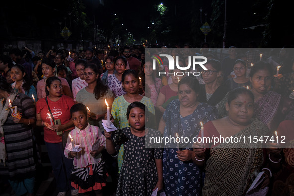 Citizens light candles in solidarity with the victim doctor who was raped and murdered at RG Kar Medical College and Hospital, during a prot...