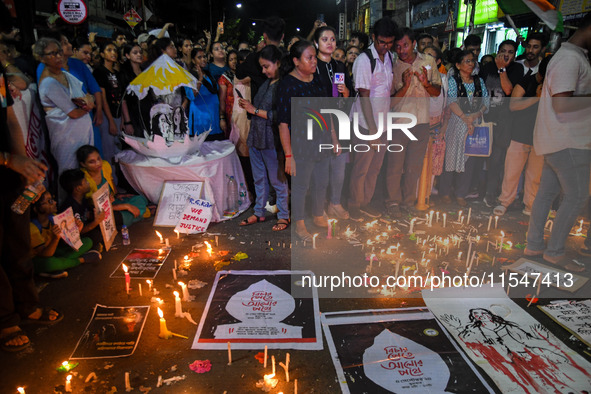 Citizens light candles in solidarity with the victim doctor who was raped and murdered at RG Kar Medical College and Hospital, during a prot...