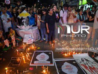 Citizens light candles in solidarity with the victim doctor who was raped and murdered at RG Kar Medical College and Hospital, during a prot...